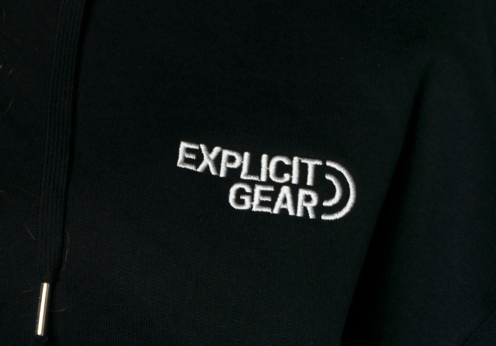 El logotipo en blanco en el pecho de una sudadera negra